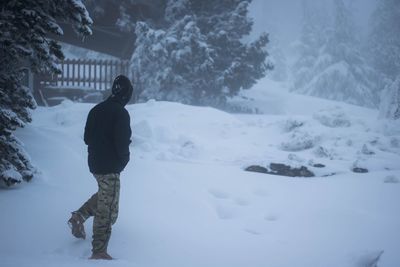 Full length of man standing in snow