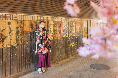 Women standing by flowering plants