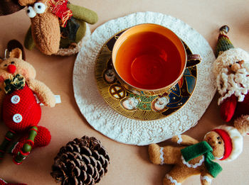 High angle view of cup of tea and christmas ornaments