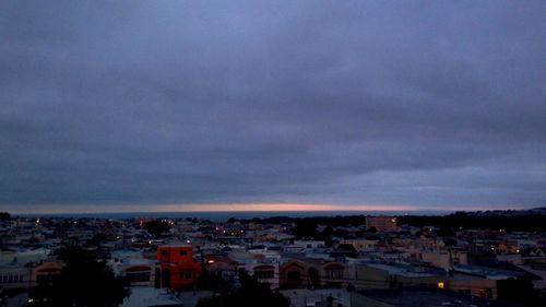 Cityscape against cloudy sky