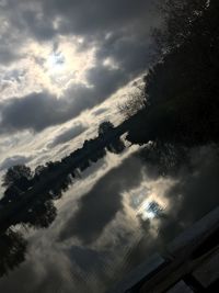 Low angle view of silhouette trees against sky