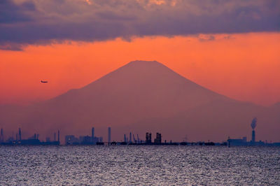 Fuji silhouette over tokyo bay at dusk.