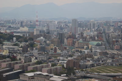 High angle view of buildings in city against sky