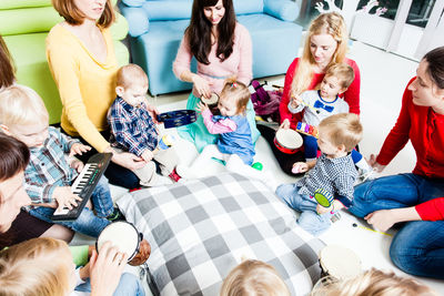 High angle view of people sitting on floor