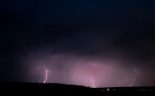 Panoramic view of lightning in sky at night