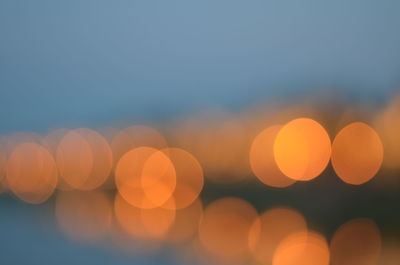 Defocused image of lights against sky at night