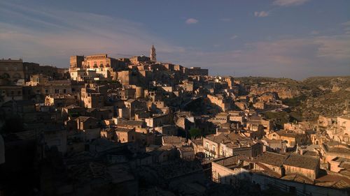 High angle view of buildings in town against sky