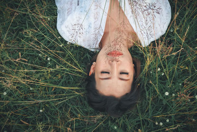 High angle view of woman lying on grass