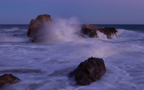 Waves crashing along the malibu coast at sunset in leo carrillo park