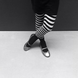 Low section of woman wearing striped stockings