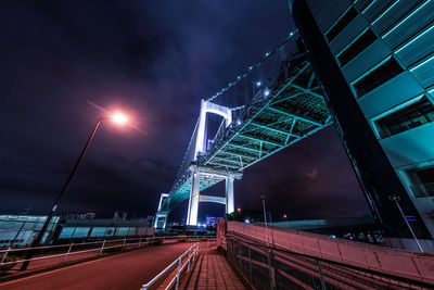 Illuminated bridge against sky at night