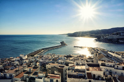 High angle view of buildings by sea against sky