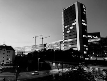 Street by buildings against sky