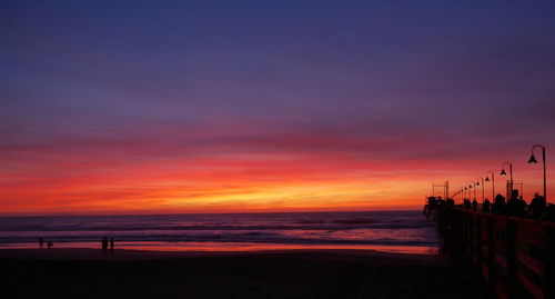 Scenic view of beach against sky during sunset
