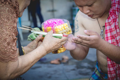 Midsection of man holding ice cream