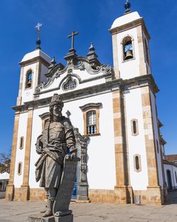 Low angle view of statue against church