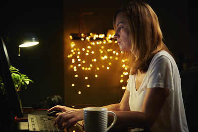 Tired woman works late at home workplace