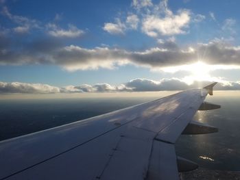 Airplane flying over sea against sky