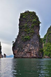 Rock formations by sea against sky