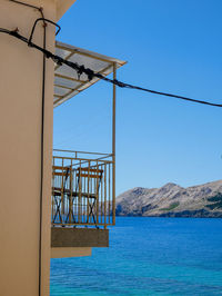View of bay against clear blue sky