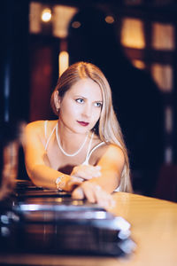 Portrait of young woman using laptop at home