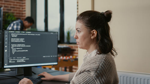 Shocked businesswoman sitting in office