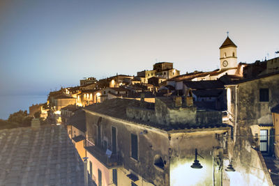 Buildings in city against clear sky