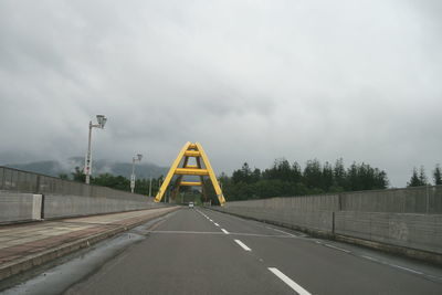 Road sign against sky