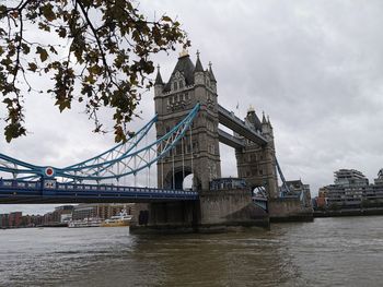 View of bridge over river against cloudy sky