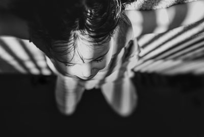 Upside down image of girl relaxing on carpet at home