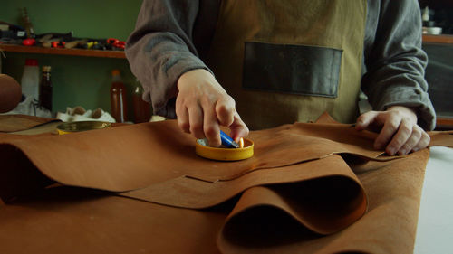 Midsection of man working on table