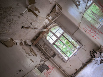 Low angle view of window in abandoned building