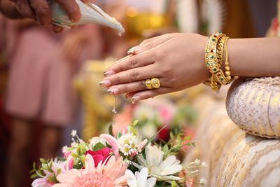 Close-up of hands holding flowers