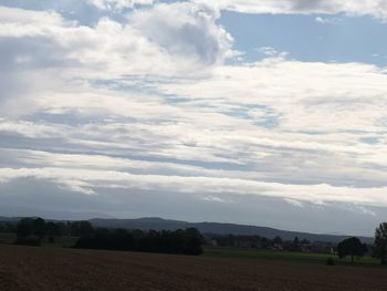 Scenic view of agricultural field against sky