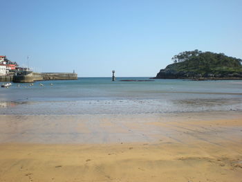 Scenic view of beach against clear sky