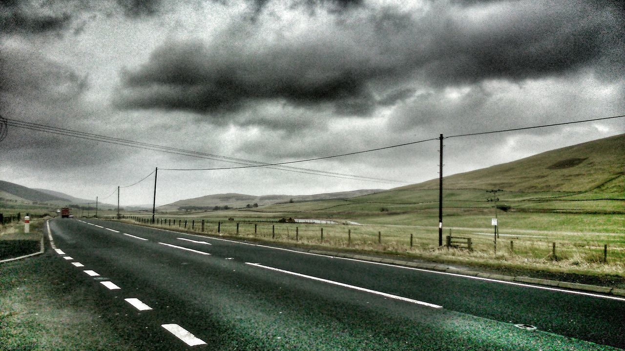 road, sky, transportation, cloud - sky, the way forward, cloudy, road marking, country road, diminishing perspective, electricity pylon, landscape, cloud, weather, highway, vanishing point, overcast, empty road, storm cloud, power line, street