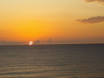 Scenic view of sea against orange sky