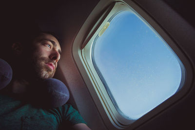 Portrait of man sitting in airplane