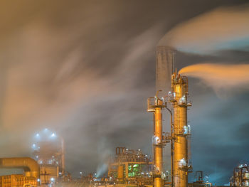 Night view of oil refinery in strong winds.