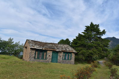 House on field against sky