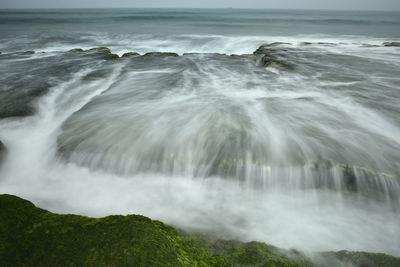 Scenic view of sea waves splashing on shore