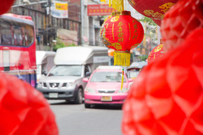 Red lanterns hanging on street in city