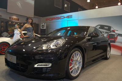 Side view of woman standing in car