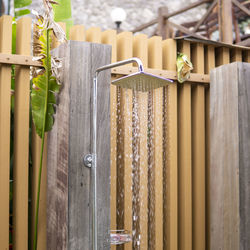 Water falling from the rain shower head of an outdoor swimming pool area.