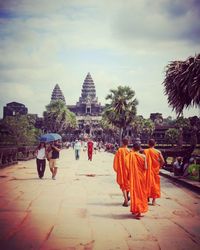 People at temple against sky