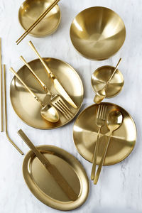 Top view various gold korean dish with sujeo spoon and chopstick. on white table