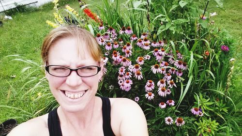 Portrait of smiling woman against plants