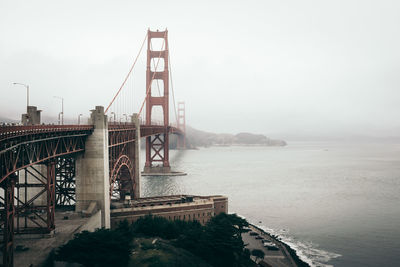 Golden gate bridge against sky during foggy weather