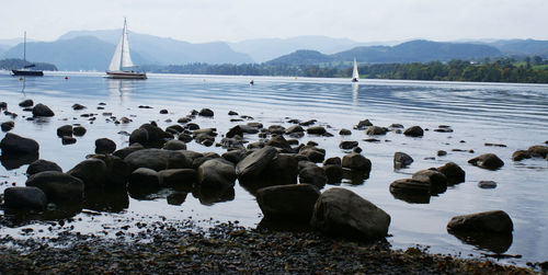 Scenic view of sea with mountains in background