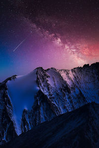 Scenic view of rock formation against sky at night